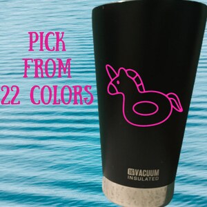 May include: Black stainless steel tumbler with a pink unicorn pool float design. The tumbler has a white lid with the text "16V Vacuum Insulated".