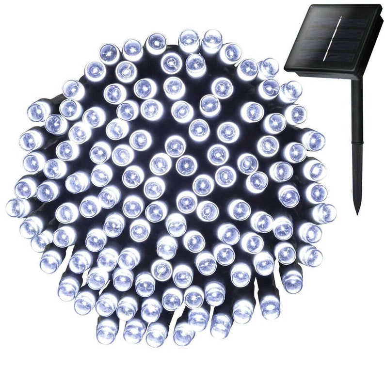 May include: A string of 50 white LED fairy lights with a solar panel and stake. The lights are strung together on a black wire and are powered by the solar panel.