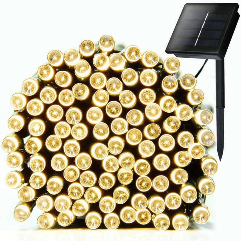 May include: A string of 100 warm white LED fairy lights with a solar panel and stake. The lights are coiled up and ready to be strung.