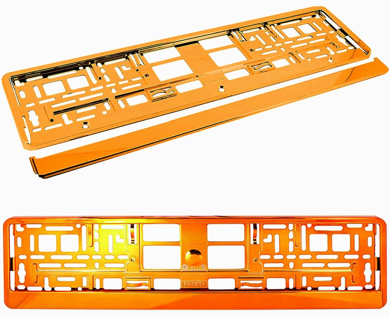 May include: Two orange-colored car license plate frames, one assembled and one disassembled, are displayed against a white background. The frames have a shiny, metallic finish and a rectangular shape with various cutouts and mounting holes.