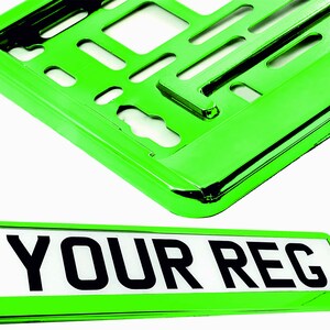 May include: Bright green license plate frame and plate. The plate has the text "YOUR REG" in bold black letters on a white background. The frame is a shiny, reflective green.