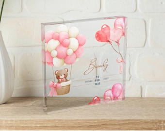 May include: A pink and white hot air balloon with a teddy bear in the basket. The balloon is surrounded by pink hearts and the text "Brandy" is written in cursive. The date "10 FEB 2023" is written below the name.