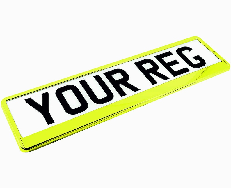May include: A rectangular license plate with the text "YOUR REG" in bold black letters on a white background. The plate is encased in a bright yellow frame, creating a striking contrast against the white background.