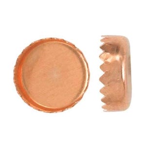 May include: Two copper-colored bezel cups for jewelry making. One is a flat circle with a textured edge, and the other is a side view of the bezel cup. The bezel cup has a scalloped edge.