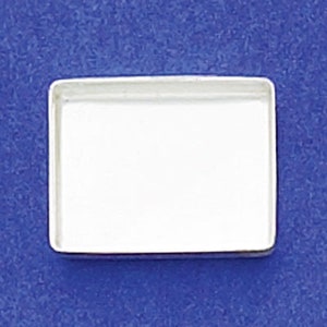 May include: A silver rectangular tray with a smooth, polished surface. The tray is empty and ready to be filled with jewelry, trinkets, or other small items.