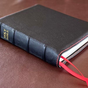 Black cowhide leather Notetaking Bible with red perimeter stitching and two red ribbons
