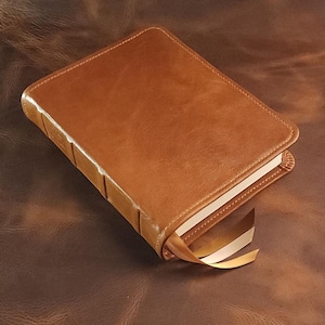 Brown sheepskin leather Legacy Standard Bible with honey brown perimeter stitching and three ribbons