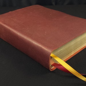 Red cowhide Every Man&#39;s Bible with two ribbons in a rugged leather style