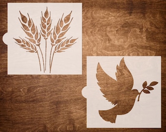 May include: Two white stencils, one with a design of wheat stalks and the other with a dove carrying an olive branch.