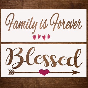 May include: White stencil with the text "Family is Forever" and four pink hearts above the text "Blessed" with an arrow and a pink heart.