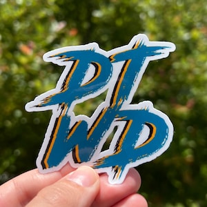 May include: A blue and yellow sticker with the text "PTWD" written in a stylized, brushstroke font.