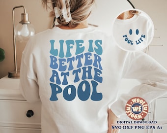 May include: White sweatshirt with blue text that reads "Life is better at the pool". The text is in a retro font style. A smaller white circle with blue text that reads "Pool Life" is in the upper right corner of the image.