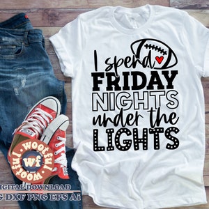 May include: White t-shirt with black text that reads "I spend FRIDAY NIGHTS under the LIGHTS" and a black and white football graphic with a red heart.