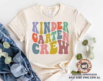 May include: A white t-shirt with the text "Kindergarten Crew" in colourful, retro-style lettering.