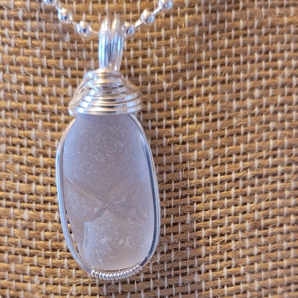 Marked with an X, sea glass pendant.