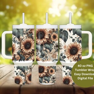 May include: Three 40 ounce white tumblers with a floral design featuring sunflowers, leaves, and a leopard print pattern. The tumblers have a handle and a straw.