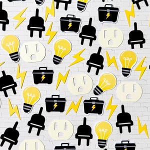May include: A collection of paper cutouts featuring yellow light bulbs, black electrical plugs, black toolboxes with yellow lightning bolt symbols, white electrical outlets, and yellow lightning bolts arranged in a repeating pattern.