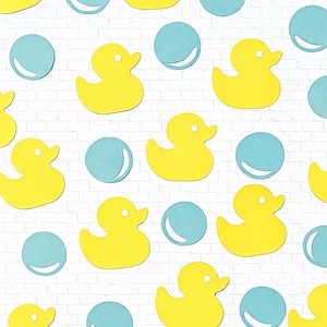 May include: A repeating pattern of yellow rubber duck cutouts and light blue bubble cutouts on a white brick background. The ducks are facing different directions.