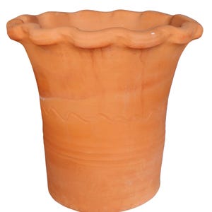 May include: A terracotta plant pot with a wavy rim. The pot has a flared shape and a decorative etched line around the middle. The pot is a warm orange-brown colour and is suitable for indoor or outdoor use.