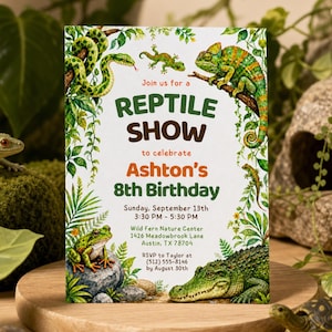 May include: A rectangular invitation card featuring watercolor illustrations of a green snake, a chameleon, a frog, and a crocodile. The text reads: Join us for a REPTILE SHOW to celebrate Ashton's 8th Birthday, Sunday, September 13th, 3:30 PM - 5:30 PM.