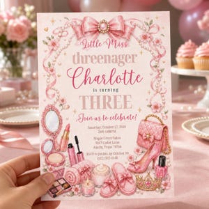 May include: A pink birthday invitation card featuring a bow, pearls, and floral accents. The text reads Little Miss threenager Charlotte is turning THREE. Illustrations include a mirror, lipstick, makeup palette, handbag, high heel, and crown.