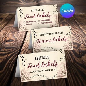 May include: Three cream-colored editable food and name labels with burgundy text and decorative borders. The food labels include options for vegetarian, vegan, dairy-free, and gluten-free. The Canva logo is in the upper right corner.