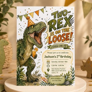 May include: A birthday invitation card featuring a green T-Rex wearing an orange party hat and holding a drink. The text reads: TWO REX IS ON THE LOOSE! A ROARING GOOD TIME. Please join us to celebrate Jackson's 2nd Birthday, Saturday, October 18th.