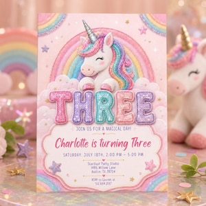 May include: A rectangular party invitation card featuring a white unicorn with a glittery horn, a rainbow, and clouds. The text reads THREE, JOIN US FOR A MAGICAL DAY, Charlotte is turning Three, Saturday, July 18th, 2:00 PM - 5:00 PM, Stardust Party Studio, 1486 Willow Lane, Austin, TX 78704, RSVP to Lauren at 512.684.2197.