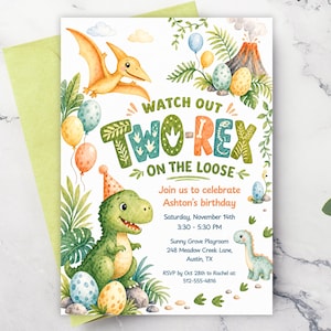May include: A birthday invitation card featuring watercolor illustrations of a green dinosaur wearing a party hat, a pterodactyl, a volcano, and dinosaur eggs. The text reads: WATCH OUT TWO-REX ON THE LOOSE, Join us to celebrate Ashton's birthday, Saturday, November 14th, 3:30 - 5:30 PM, Sunny Grove Playroom, 248 Meadow Creek Lane, Austin, TX, RSVP by Oct 28th to Rachel at: 512-555-4816.