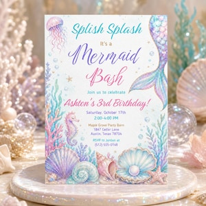 May include: A rectangular birthday invitation card featuring a mermaid tail, jellyfish, seahorse, and seashells in pastel colours. The text reads: Splish Splash It's a Mermaid Bash Join us to celebrate Ashton's 3rd Birthday! Saturday, October 17th 2:00-4:00 PM Maple Grove Party Barn 1847 Cedar Lane Austin, Texas 78704 RSVP to Jordan at (512) 555-0148.