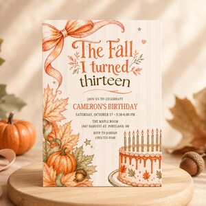 May include: A rectangular birthday invitation card featuring an orange ribbon, autumn leaves, and a pumpkin illustration. The text reads: The Fall I turned thirteen, Join us to celebrate Cameron's Birthday, Saturday, October 17, 3:30-6:00 PM, The Maple Room, 1847 Harvest Av, Portland, OR, RSVP to Jordan (503) 555-0148. A cake with candles is at the bottom.