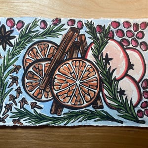 May include: Watercolor painting of a simmer pot with orange slices, cinnamon sticks, apple slices, star anise, cloves, and rosemary sprigs. The painting is on a light blue background with the text "Simmer Pot II" and the date "2024".