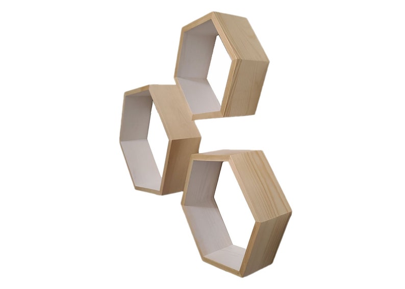 May include: Three wooden hexagonal shelves in a natural wood finish. The shelves are stacked on top of each other and are angled to create a unique and modern look.