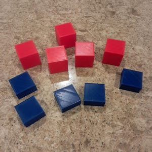 May include: A collection of red and blue blocks. There are five red blocks and five blue blocks.