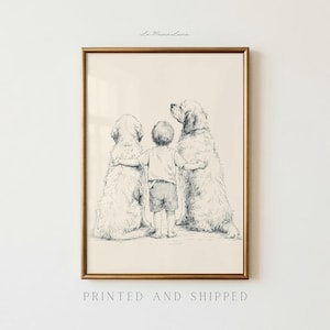 May include: A framed black and white line drawing print featuring a child standing between two large dogs, with their arms around the dogs' backs. The child wears a t-shirt and shorts. The text La Mama Luna is printed at the top of the frame.