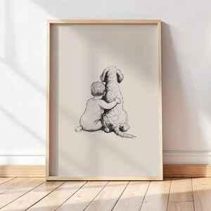 May include: A framed print featuring a pencil sketch of a child embracing a dog. The artwork is in grayscale, with the child's back facing the viewer. The dog has a fluffy coat. The frame is a light wood color.