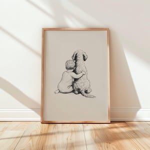 May include: A framed pencil sketch depicts a child hugging a dog. The artwork is in a light beige frame, leaning against a white wall. The dog has a fluffy coat, and the child is wearing a onesie. The floor is made of light-colored wood.