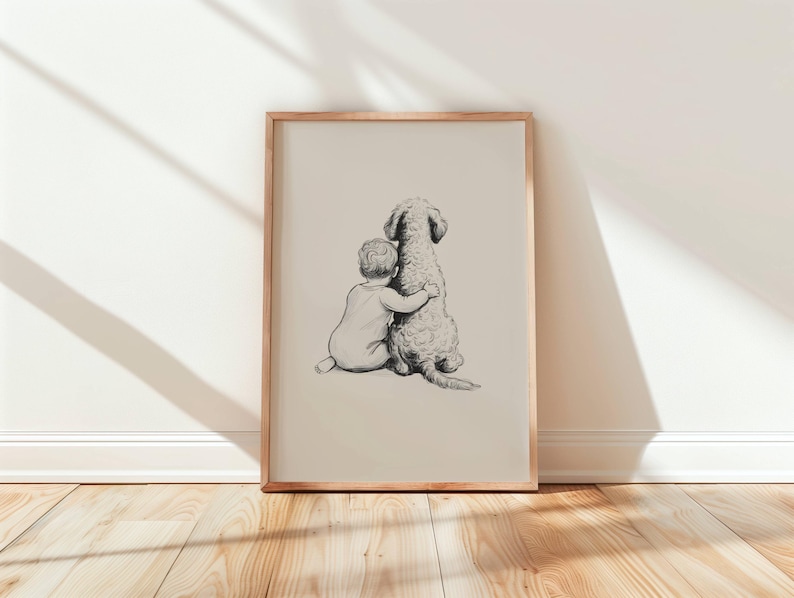 May include: A framed pencil sketch depicts a child hugging a dog. The artwork is in a light beige frame, leaning against a white wall. The dog has a fluffy coat, and the child is wearing a onesie. The floor is made of light-colored wood.