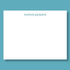 May include: A white stationery card with the name "NATHAN JACKSON" printed in teal blue ink at the top.