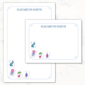 May include: A vertical stationery sheet and a horizontal note card, both white with a light blue border and the name ELIZABETH SMITH printed in blue. Each features colorful mahjong tile illustrations including a peacock, vase, and joker.