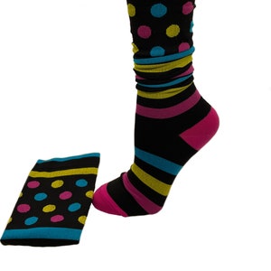 May include: Black knee-high socks with yellow, pink, and blue stripes and polka dots.
