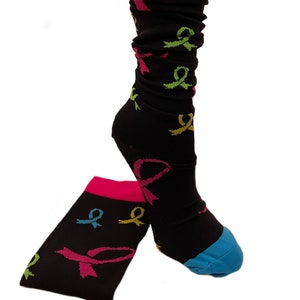 May include: Black knee-high socks with a pink cuff and a blue toe. The socks feature a repeating pattern of colorful ribbon designs.