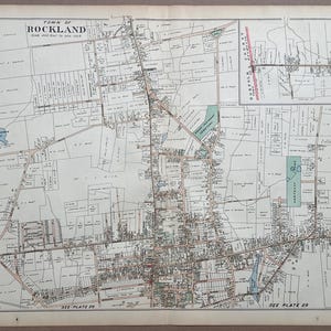 May include: A vintage black and white map titled Town of Rockland Plate 28, featuring detailed property lines, street layouts, and land parcels. The map includes a scale of 400 feet to one inch, a small inset map, and light blue shaded water features.