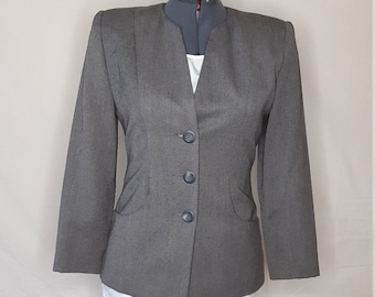 May include: A gray blazer with a V-neck and four buttons. The blazer has a slightly fitted silhouette and is made of a textured fabric.