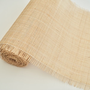 May include: A roll of natural hessian mesh fabric with a fringed edge. The mesh is woven with a fine, even pattern.