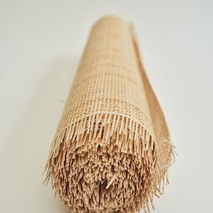 May include: A roll of natural woven cane webbing, a material used for chair seats and other furniture upholstery.