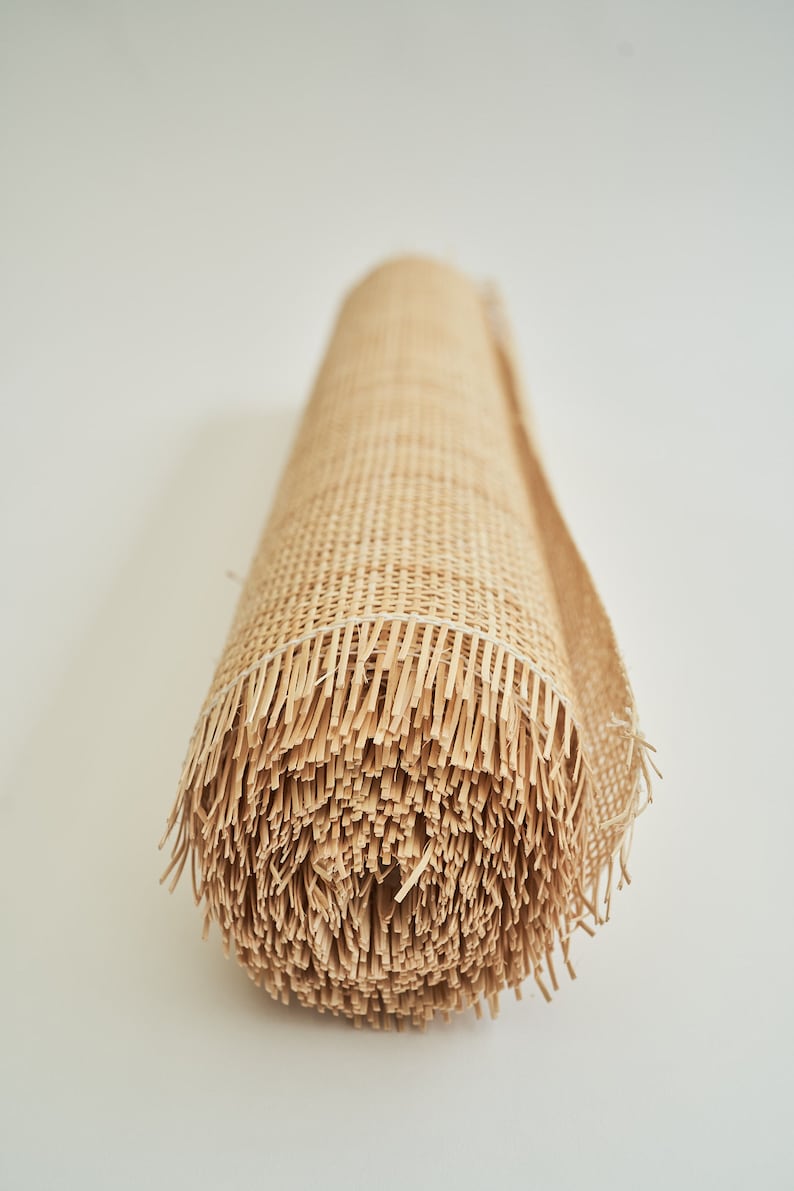 May include: A roll of natural woven cane webbing, a material used for chair seats and other furniture upholstery.