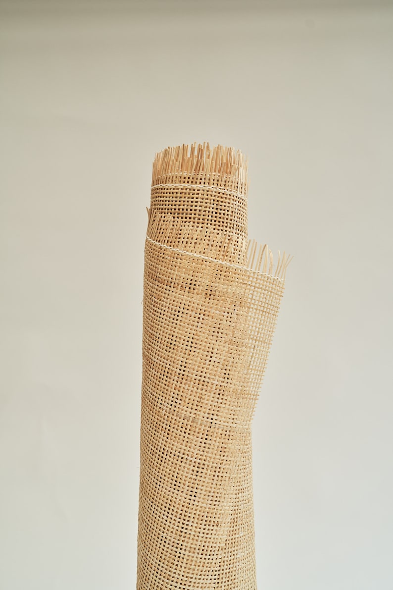 May include: A roll of natural-coloured cane webbing, a woven material used for chair seats and other furniture upholstery.