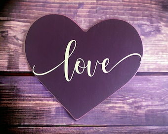 Romantic Charm: 9" x 8" Heart-Shaped Wood Sign Painted Burgundy with "Love" Vinyl Lettering in Cream Script Font.