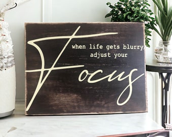 Stay Focused and Inspired with this 6" x 8" Brown Wood Canvas Sign with Cream 'When Life Gets Blurry Adjust Your Focus' Lettering